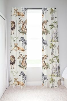 the curtains in this bedroom are decorated with wild animals and zebras on white fabric