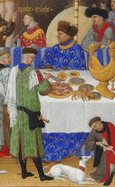 an image of a medieval painting of people and dogs at a table with food on it