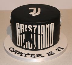 a black and white cake with the words cristianoo on it's side