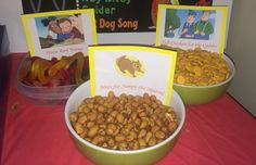 two bowls filled with peanuts sitting on top of a red table cloth covered tablecloth