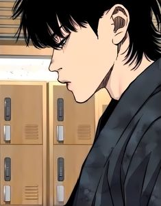 a man with black hair standing in front of lockers