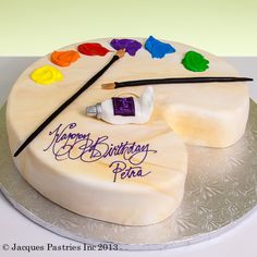 a birthday cake with an artist's palette on it