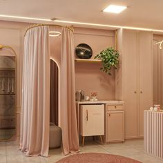 a bathroom with pink walls and beige curtains