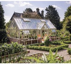 a garden with lots of plants in it and a glass house on the top floor