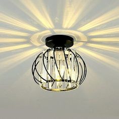 a light that is hanging from the ceiling with some lights on it's side