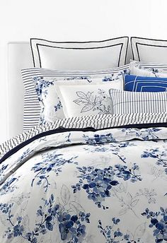 a bed with blue and white flowers on it