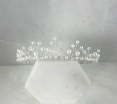 This pretty pearl and crystal tiara is hand wired with white pearls and sparkling clear AB crystals in a delicate design.  Made on a silver plated band. Height at tallest centre point: 2.5cm Perfect for flower girls, holy communions and christenings. Sent in a signature Queenie & Lily gift box. *Made with small parts, please supervise children at all times when being worn. Leaf Headband Wedding, Communion Tiara, Tiara Flower, Flower Girl Tiara, Girls Tiara, Flower Tiara, Pearl Tiara, Crystal Tiara, Headband Tiara