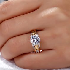 a woman's hand with a yellow and white diamond ring on top of her finger