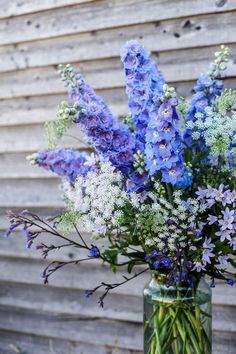 a vase filled with purple and white flowers