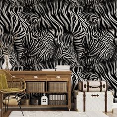 a zebra print wallpaper in a living room with a chair and suitcases on the floor