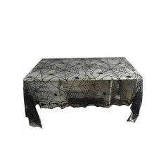 a table with spider webs on it and black lace around the edges, sitting on top of a white surface