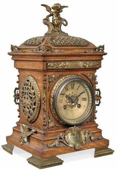 an ornate wooden clock with angel figurine on top