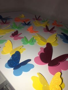 the table is covered with many different colored butterflies