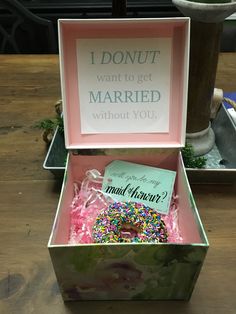 an open box that has a donut inside of it on top of a table