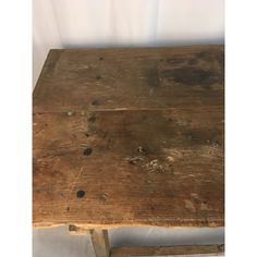 an old wooden bench with holes in it