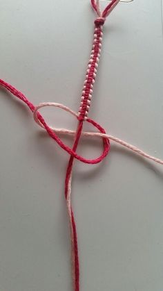 a piece of red and white string on top of a table