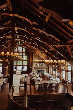 the inside of a building with tables and chairs set up for a formal function in it