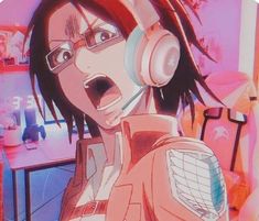 an anime character with headphones on in front of a computer desk and wallpaper