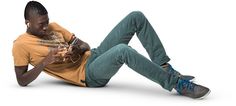 a man laying on the ground holding a cell phone