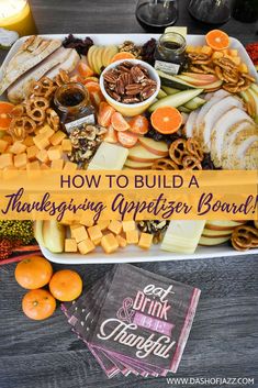 a thanksgiving appetizer board with oranges, apples and pretzels