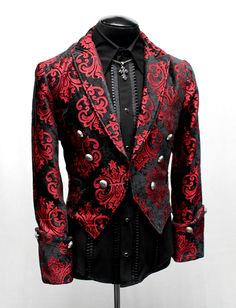 A stylish formal jacket blending the medieval with modern style. Made in luxurious red on black velvet brocade fabric with an ornate fleur de lis design on it. Extra wide cuffs and pointy lapels add a vintage style. Antique metal medieval lion buttons decorate the front and the cuffs. Lined inside with sleek black satin. A small pocket on either side in front. This jacket is perfect for the stage or for a luxurious dinner party. Comes in sizes Small to 3X. Size Measurements: Small - Chest 40" Waist 30-32" Medium - Chest 42-44" Waist 34" Large - Chest 46" Waist 36" XL - Chest 49" Waist 40-42" XXL - Chest 51" Waist 45" 3X - Chest 54" Waist 48" Red Fitted Blazer For Costume Party, Elegant Red Costume Outerwear, Black Brocade Long Sleeve Outerwear, Fitted Red Ceremonial Outerwear, Fitted Red Outerwear For Ceremonial Occasions, Luxurious Dinner, Velvet Dinner Jacket, Fancy Suit, Formal Jacket