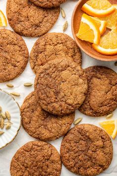 several cookies and orange slices on a table