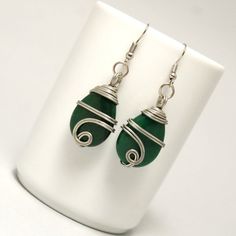 These handmade wire wrapped emerald earrings unique piece you are holding was made by hand especially for you. . These Silver Wire Wrapped Emerald Earrings are simply stunning and perfect for livening up an everyday outfit. I can offer matching earrings, necklace and bracelet. My other pieces here: https://www.etsy.com/shop/BeyhanAkman My EmeraldEarrings is coated with a durable clear non-toxic polymer to prevent tarnishing and oxidation formation. You'll receive this in a lovely gift wrapped bo Handmade Green Wrap Earrings As Gift, Wire Wrapped Wrap Earrings As A Gift, Green Wrap Earrings For Gift, Green Wire Wrapped Metal Earrings, Green Dangle Wrap Earrings With Ear Wire, Green Wire Wrapped Drop Earrings, Green Drop Wrap Earrings With Ear Wire, Green Wrap Drop Earrings With Ear Wire, Silver-plated Wire Wrapped Earrings As Gift