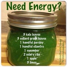 a jar filled with green liquid sitting on top of a wooden table