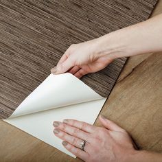 a woman is wrapping up a piece of paper