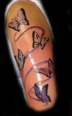 a woman's arm with butterflies on it and the word love written in purple ink