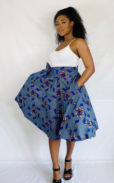 "Go dancing in this fun  Side Belted Umbrella Skirt with Pockets!  This piece is fastened with an elastic waistband and fits size Small to Large. Model is a size medium and 5'6\" tall. Length: 25\" Material: 100% Cotton Ankara Fabric. Free size customization available." African Attire Dresses, Umbrella Skirt, Ankara Fabric, Skirt With Pockets, African Attire, Circle Skirt, Skirts With Pockets, Comfortable Outfits, African Print