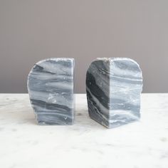 two marble blocks sitting on top of a table