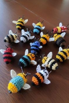 small crocheted bees sitting on top of a wooden table