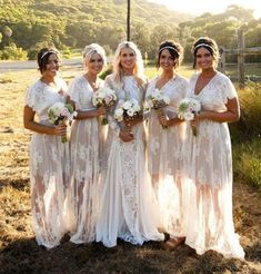 a group of women standing next to each other in front of a fence and grass field