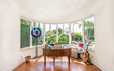 a living room filled with furniture and lots of windows