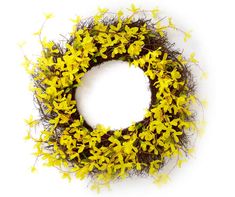 a wreath with yellow flowers is shown on a white background and looks like it's made out of twigs