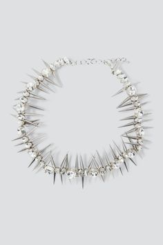 Crystal Clear Rhinestone Studded Chokere from Collina Strada. Rhinestone choker necklace with spiky details. Adjustable chain length. This is a costume jewelry piece. Please use care with this item and do not wear while bathing or swimming. Excessive wear may cause the finish to deteriorate. - Acrylic / brass - Made in India - Chain length: 13-17" Punk Spiked Choker For Parties, Punk Spikes Choker For Party, Edgy Spiked Choker For Party, Party Choker With Spikes, Edgy Spiked Jewelry For Parties, Spiky Choker, Spike Choker, Studded Choker, Rhinestone Choker Necklace