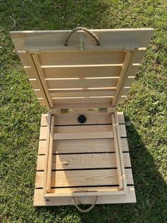 an empty wooden box sitting in the grass