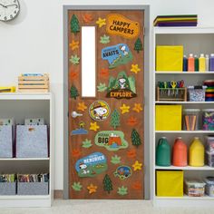 a wooden door with stickers on it next to bookshelves and a clock