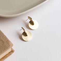 These brass earrings have a minimalist design perfect for architecture lovers. The design cosist of the intersection of a disc and a half disc. Its geometric shape is inspired by the Bauhaus movement and Moholy Nagy's paintings. Like all my jewelry, these earrings have been designed and manufactured by me in my Madrid workshop. The material of the earrings is brass with matte finish, but the post and the ear back are made of silver to avoid problems of allergic reactions. MATERIALS and FINISHES Minimalist Circle Earrings As Gift, Nickel-free Round Minimalist Earrings, Minimalist Circle Brass Earrings, Minimalist Round Brass Earrings, Minimalist Nickel-free Circular Earrings, Minimalist Nickel-free Circle Earrings, Nickel Free Minimalist Circle Earrings, Nickel-free Minimalist Circle Earrings, Minimalist Jewelry With Matching Round Disc Earrings