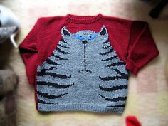 a sweater with a cat drawn on it