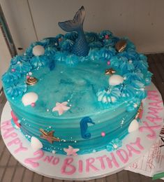 a birthday cake with blue frosting and decorations