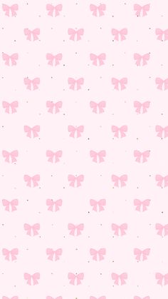 a pink wallpaper with small bows on it