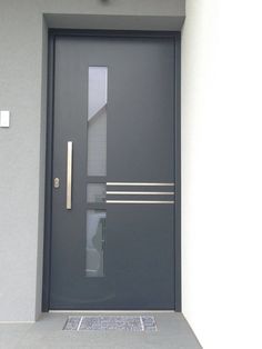 the front door to a building with a metal handle on it