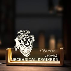 an illuminated plaque with a mechanical engineer heart on it