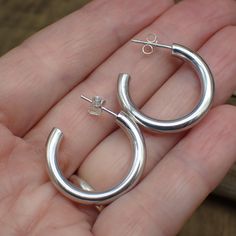 These sterling silver post hoop earrings are perfect for everyday wear. Intricately crafted from sterling silver, the simple design will add a bit of sparkle to any outfit. Simple and stylish, they are sure to become a staple in any jewelry collection. Dimensions: 25 mm x 25 mm Classic Sterling Silver Huggie Earrings For Everyday, Minimalist Hallmarked Small Hoop Huggie Earrings, Classic Small Hoop Sterling Silver Jewelry, Minimalist Small Hoop Jewelry With Sterling Silver Clasp, Classic Small Hoop Sterling Silver Earrings, Minimalist Polished Sterling Silver Huggie Earrings, Sterling Silver Huggie Earrings For Gifting, Gift Sterling Silver Huggie Earrings, Sterling Silver Rounded Jewelry With Polished Finish