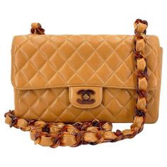 Store item: 68030 Classic Chanel vintage is this quilted caramel beige lambskin single flap with tortoise shell resin hardware. In the perfect classic medium size, with chunky lightweight single woven chain strap and CC turnlock with resin hardware. Unique philips screws on the back plate which is unique only to tortoise shell resin flaps from Chanel. A statement vintage piece in very rare condition. For 20 years, Boutique Patina has specialized in sourcing and curating the most pristine vintage Vintage Quilted Shoulder Bag For Formal Occasions, Vintage Quilted Leather Shoulder Bag, Vintage Quilted Leather Bag, Formal Vintage Quilted Shoulder Bag, Elegant Brown Flap Bag With Cc Turnlock Closure, Designer Brown Shoulder Bag With Cc Turnlock Closure, Classic Brown Bag With Cc Turnlock Closure, Classic Brown Shoulder Bag With Cc Turnlock Closure, Luxury Brown Double Flap Bag