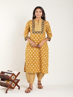 Mustard Yellow dabu flower printed straight kurta, has a mandarin collar, mirror and katha embroidered yoke, three-quarter sleeves and stripes Print afgani Pants has Elasticated Waistband Fabric: 100% Cotton Color: Mustard Yellow Note: Available in other colors Wash Care Instruction - Dry Clean Only The product will be shipped within 15-20 days of order placed Size Chart: Kurta Size XS S M L XL XXL XXXL Bust 36 38 40 42 44 46 Waist 32 34 36 38 40 42 Hip 38 40 42 44 46 48 Shoulder 14 14.5 15 15.5 Straight Kurta, Kurta Set, Mandarin Collar, Three Quarter Sleeves, Yellow Floral, Quarter Sleeve, Floral Printed, Mustard Yellow, Stripe Print