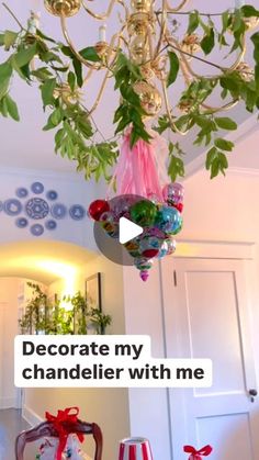 a chandelier hanging from the ceiling in a living room with decorations on it