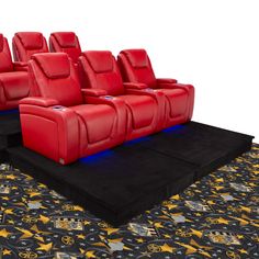 rows of red leather seats sitting on top of a black carpeted area next to a rug